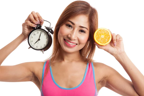 Mooie Aziatische gezond meisje met sinaasappel en klok — Stockfoto