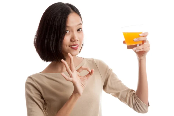 Young Asian woman show OK drink orange juice — Stock Photo, Image