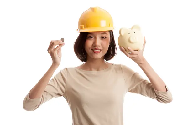 Asian engineer woman with a coin and piggy coin bank — Stock Photo, Image