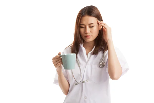 Asian young female doctor got headache with a cup of coffee. — Stock Photo, Image