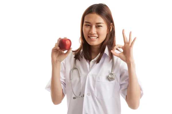 Giovane asiatico dottore mostra OK con mela . — Foto Stock
