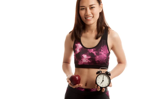 Schöne asiatische gesunde Mädchen mit Uhr und Apfel. — Stockfoto