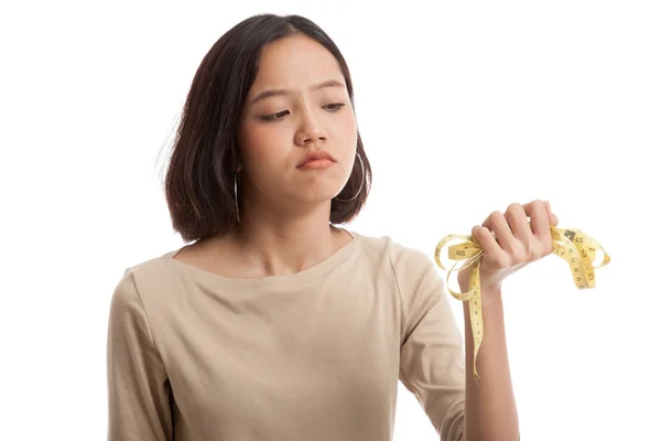 Unhappy young Asian business woman with measuring tape — Stock Photo, Image