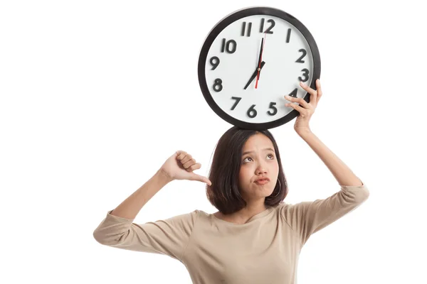 Young Asian business woman thumbs down with a clock — Stock Photo, Image