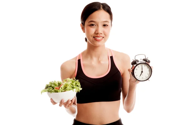 Beautiful Asian healthy girl with clock and salad — Stock Photo, Image