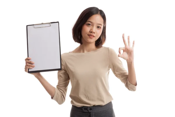 Young Asian business woman show OK and blank clipboard Royalty Free Stock Images