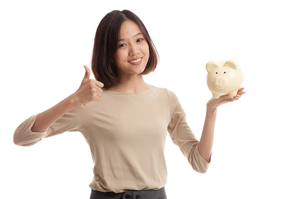 Asian business woman thumbs up with pig coin bank — Stock Photo, Image