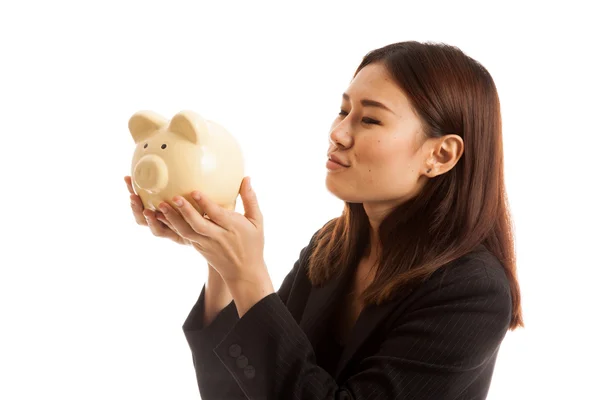 Joven asiática mujer de negocios beso un rosa moneda banco . — Foto de Stock