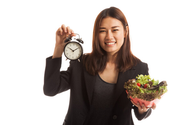 Young Asian business woman with clock and salad.