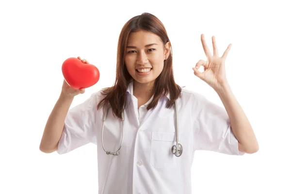 Young Asian female doctor show OK sign with red heart. — Stock Photo, Image