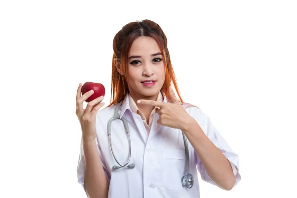 Young Asian female doctor point to an apple. — Stock Photo, Image