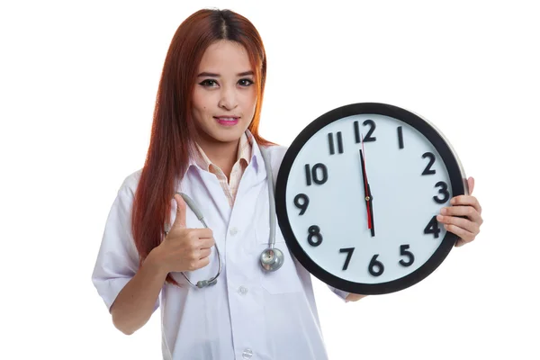 Young Asian female doctor thumbs up with a clock. — Stock Photo, Image