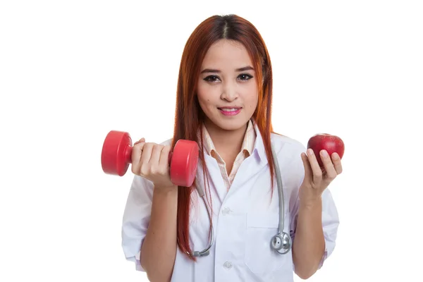 Young Asian female doctor  hold apple and dumbbell. — Stock Photo, Image