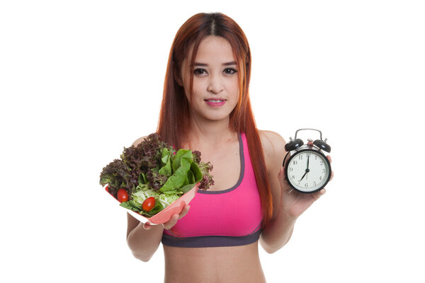 Beautiful Asian healthy girl with clock and salad.