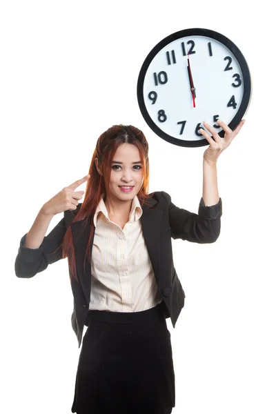 Young Asian business woman point to a clock. — Stock Photo, Image