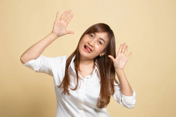 Young Asian Woman Sticking Her Tongue Out Beige Background — Stock Photo, Image