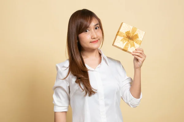 Jeune Femme Asiatique Avec Une Boîte Cadeau Sur Fond Beige Image En Vente