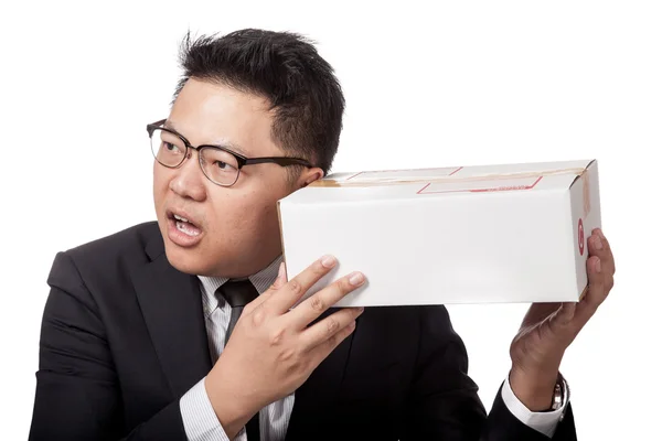 Asian businessman is curious what inside a box — Stock Photo, Image