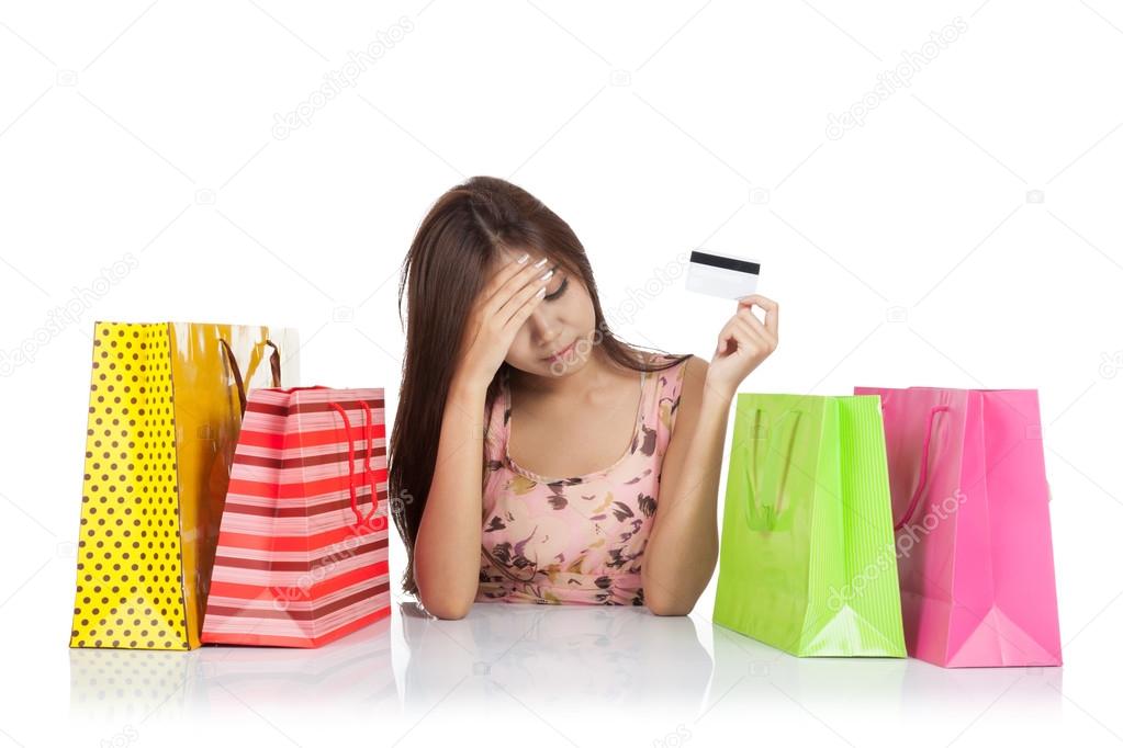 Beautiful Asian woman fed up with a credit card and shopping bag