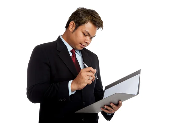 Asian businessman sign signature in a report — Stock Photo, Image