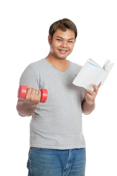 Homem asiático feliz segurar livro e halteres vermelhos — Fotografia de Stock
