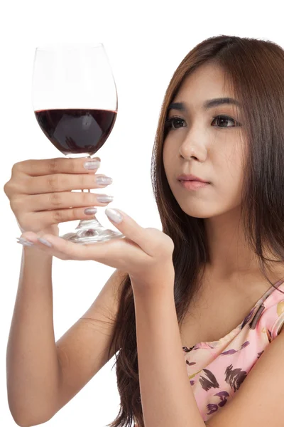 Beautiful Asian woman looking at  red wine — Stock Photo, Image