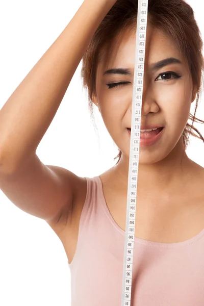 Asian slim girl wink her eye with measuring tape — Stock Photo, Image