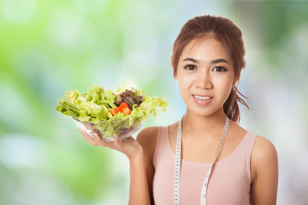 Asian skinny girl with measuring tape and salad — Stock Photo, Image