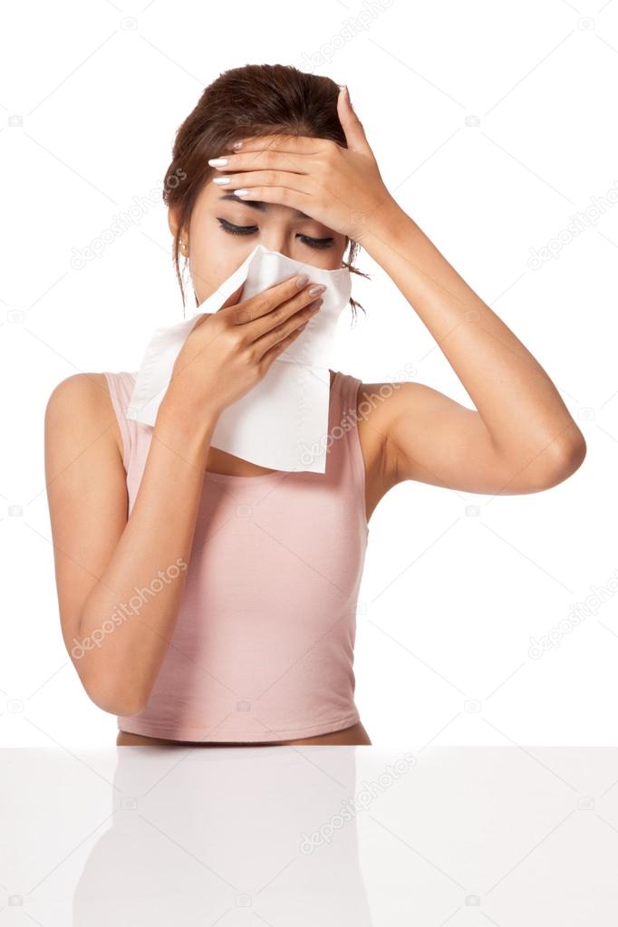 Pretty Asian girl Caught Cold. Sneezing into Tissue.