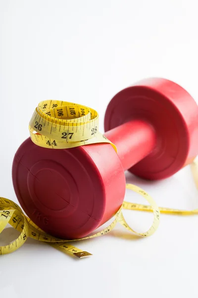 Red dumbbells weight with measuring tape — Stock Photo, Image