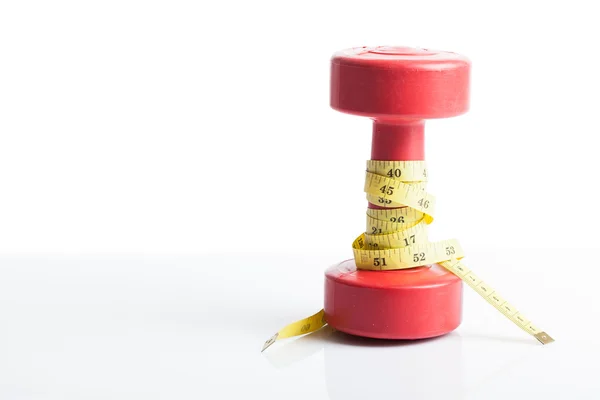 Red dumbbells weight with measuring tape — Stock Photo, Image