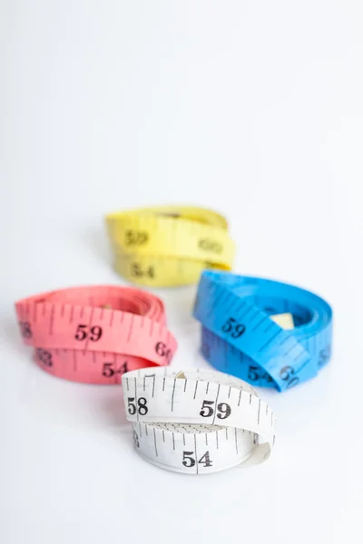 Four roll of colorful measuring tapes — Stock Photo, Image
