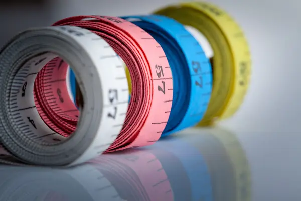 Four rolls of colorful measuring tapes — Stock Photo, Image