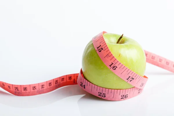 Measuring tape with green apple — Stock Photo, Image