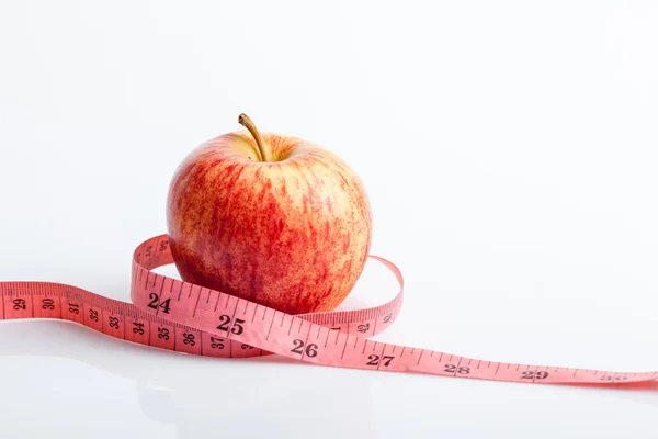 Measuring tape with red apple — Stock Photo, Image