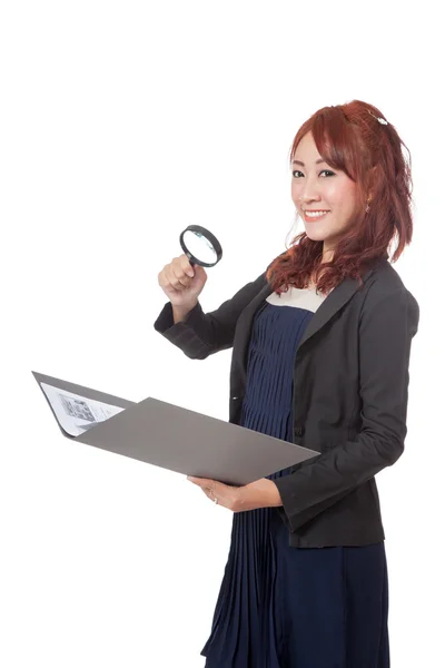 Asian office girl use magnifying glass check on data and smile — Stock Photo, Image