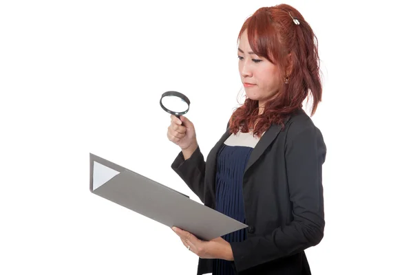 Asian office girl use magnifying glass check on data — Stock Photo, Image