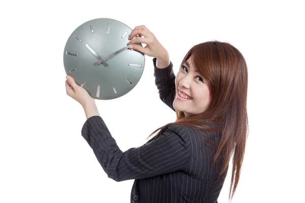 Asian Businesswoman move a clock hand and turn back — Stock Photo, Image