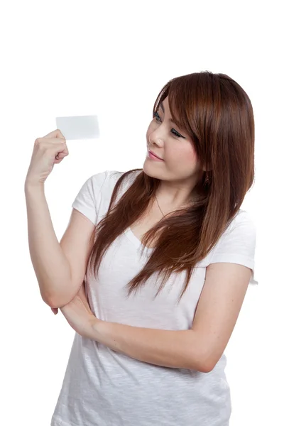 Asiática chica mira un blanco tarjeta en su mano —  Fotos de Stock