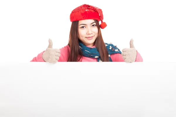 Asian girl with red christmas hat two thumbs up behind blank sig — Stock Photo, Image