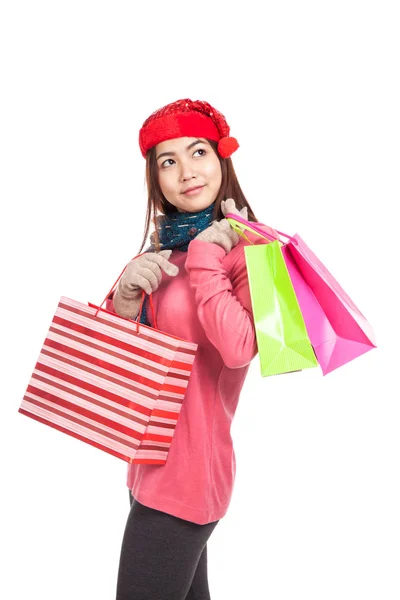 Asian girl with red christmas hat with shopping bags — Stock Photo, Image