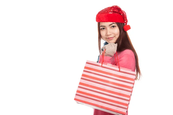 Asian girl with red christmas hat with shopping bag — Stock Photo, Image