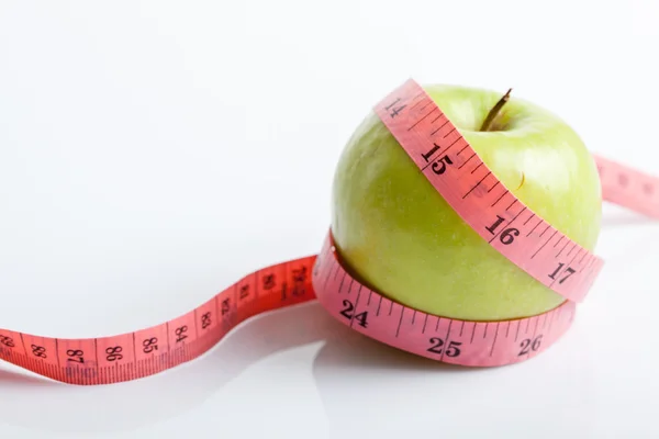 Measuring tape with green apple — Stock Photo, Image