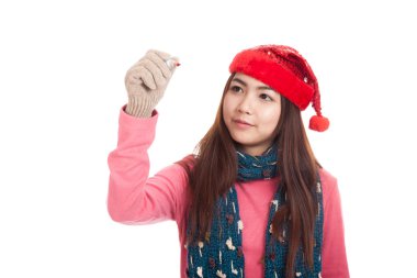 Asyalı kız kırmızı Noel şapka ile kırmızı kalemle yazmak