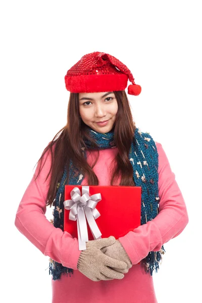 Asian girl with red christmas hat hugs a gift box — Stock Photo, Image