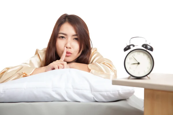 Happy Asian girl  wake up show quiet sign  with alarm clock — Stock Photo, Image