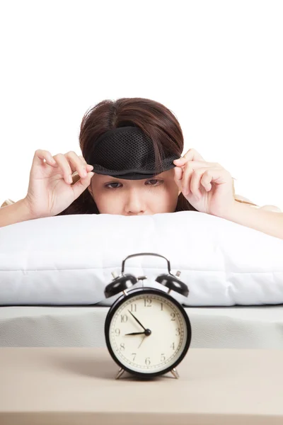 Sleepy Asian girl with eye mask and alarm clock — Stock Photo, Image