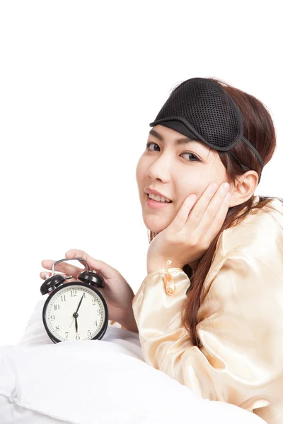 Happy Asian girl wake up with eye mask  and alarm clock — Stock Photo, Image