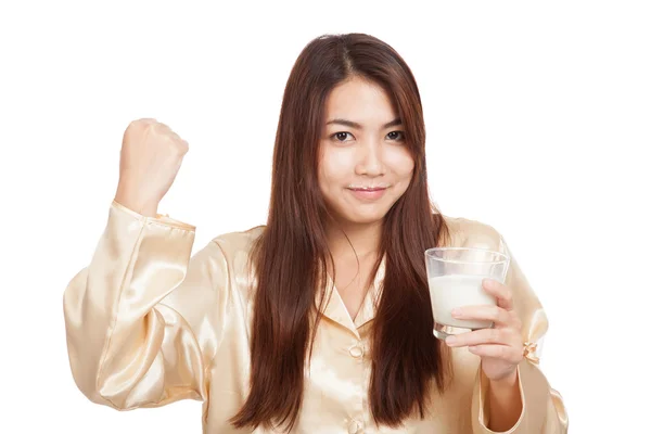 Healthy Asian woman in pajamas fist up with glass of milk — Stock Photo, Image