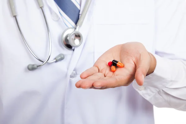 Asian male doctor with pills on his palm hand — Stock Photo, Image